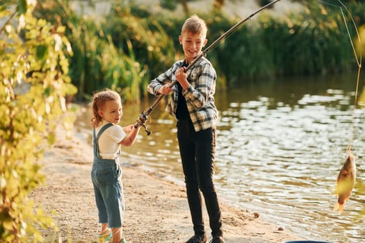 Having fun. Boy with his sister in on fishion outdoors at summertime together.
