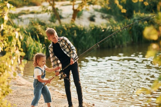 Having fun. Boy with his sister in on fishion outdoors at summertime together.