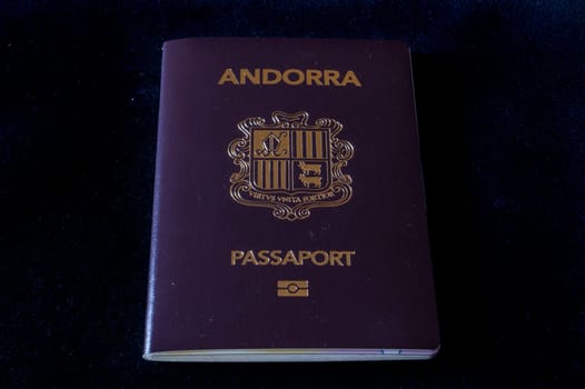 Passport of the Principality of Andorra on a black background.