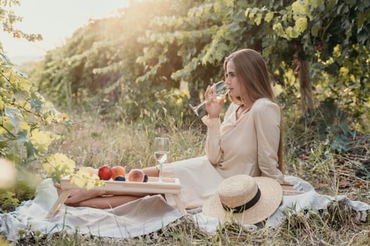 Picnic and wine tasting at sunset in the hills of Italy, Tuscany. Vineyards and open nature in the summer. Romantic dinner, fruit and wine.