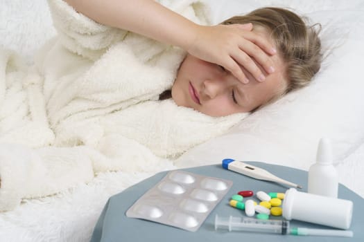 A sick teenage girl clings to her head. Medical concept.