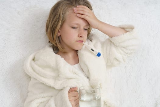 A sick teenage girl clings to her head. Medical concept.