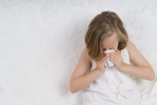 Teenage girl wipes her nose, runny nose. Medical concept.