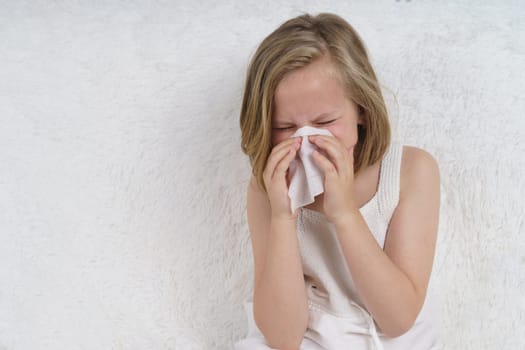 Teenage girl wipes her nose, runny nose. Medical concept.