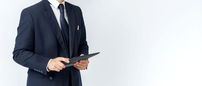 Portrait of a businessman in a blue suit holding an electronic tablet on a white background. No face visible. Business and finance concept