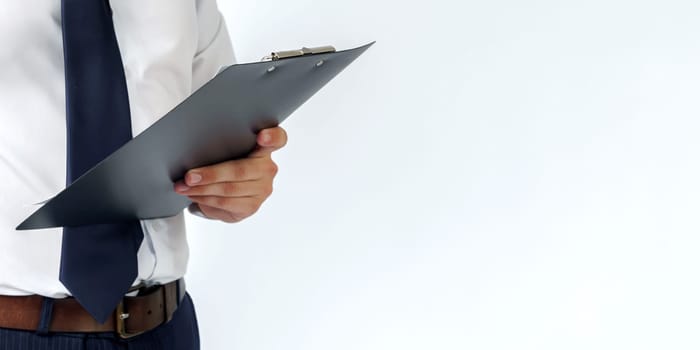 Businessman in a blue suit holds a folder in his hands on a white background. No face visible. Business and finance concept