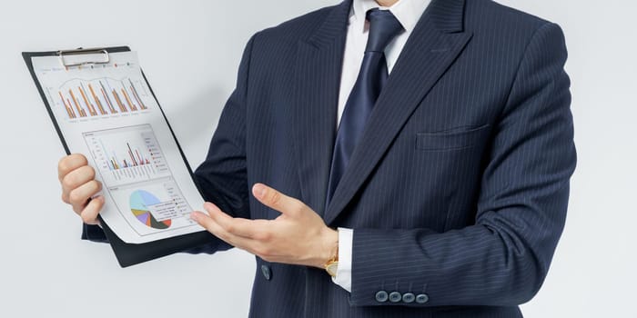 Businessman holds in his hands a tablet with reports. White background. No face visible. Business and finance concept