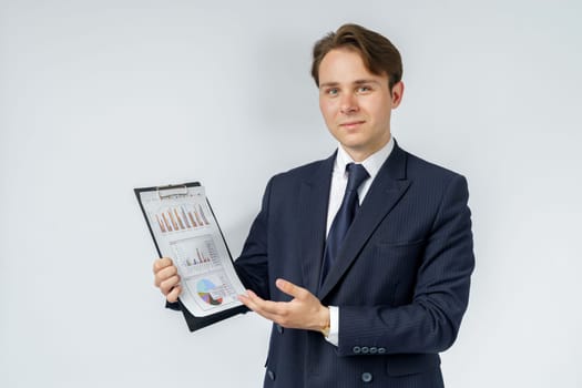 Businessman holds in his hands a tablet with reports. White background. Business and finance concept