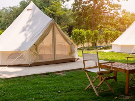 Camping picnic tent campground in outdoor hiking forest. Camper while campsite in nature background at summer trip camp. Adventure Travel Vacation concept