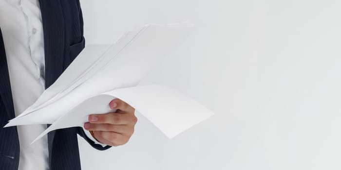 Portrait of a businessman who is talking on the phone and reading documents. No face visible. White background. Business and finance concept