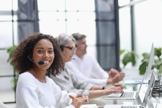 african american operator smiling in a call center.