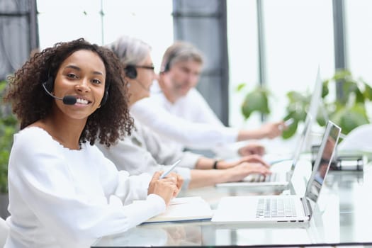 african american operator smiling in a call center.