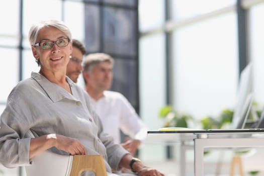 60 year old business woman in a work environment.