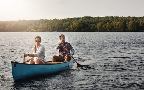 Taking in the beauty of the lake by canoe. a young couple going for a canoe ride on the lake