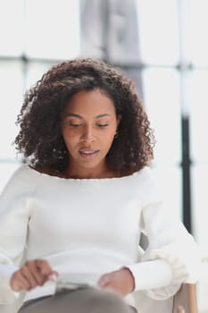 Portrait of a young attractive African American woman using a smartphone.