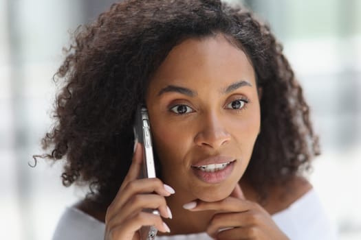 Portrait of a young African American woman talking on the phone