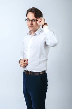 Business and finance concept. A man in a white shirt with glasses. Light background
