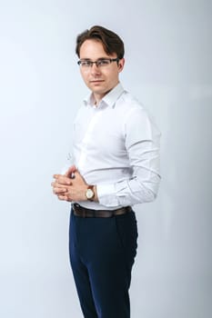 Business and finance concept. A man in a white shirt with glasses. Light background