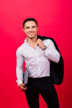 Cheerful young guy 20s in classic shirt isolated on a bright red wall background studio portrait.