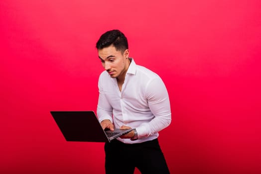 Cheerful young guy 20s in classic shirt isolated on a bright red wall background studio portrait.