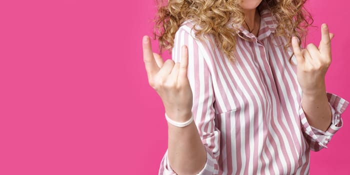 Close up photo of beautiful astonished lady fingers show V-sign toothy beaming smile. Isolated pink background