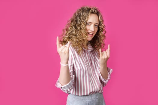 Close up photo of beautiful astonished lady fingers show V-sign toothy beaming smile. Isolated pink background