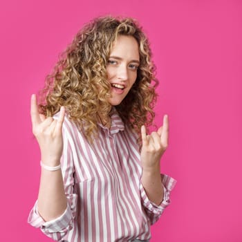 Close up photo of beautiful astonished lady fingers show V-sign toothy beaming smile. Isolated pink background