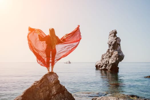 Woman travel sea. Happy tourist taking picture outdoors for memories. Woman traveler looks at the edge of the cliff on the sea bay of mountains, sharing travel adventure journey.