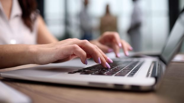 The girl's hands prints text on the laptop keyboard. Freelancer concept.
