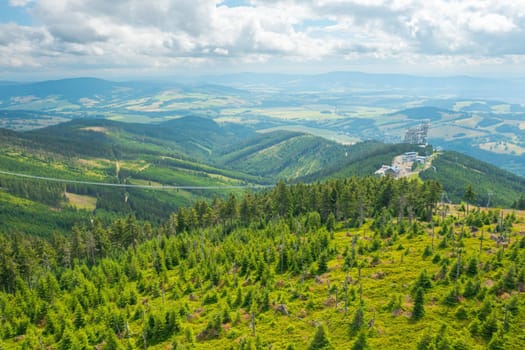 Sky walk observation tower in the forest between mountain hills near Sky Bridge 721 in a sunny summer day, Dolni Morava, Czech Republic.