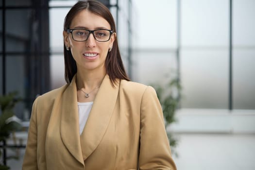 Attractive woman looking pensively at the camera in office