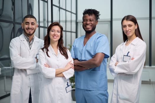 male and female healthcare workers standing in corridor at hospital