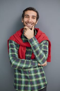 young unshaven business man posing against gray wall background studio portrait. Achieving career wealth business concept.