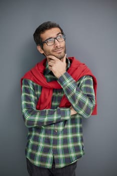 Handsome man in plaid shirt isolated on gray background