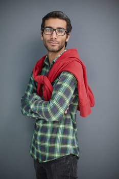 Stylish young man posing in the studio on gray background