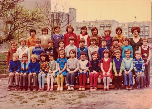 THE CZECHOSLOVAK SOCIALIST REPUBLIC - CIRCA 1980s: Retro photo shows pupils (schoolmates) and their female teacher. Color photo.