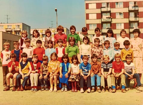 THE CZECHOSLOVAK SOCIALIST REPUBLIC - CIRCA 1980s: Retro photo shows pupils (schoolmates) and their female teacher. Color photography.