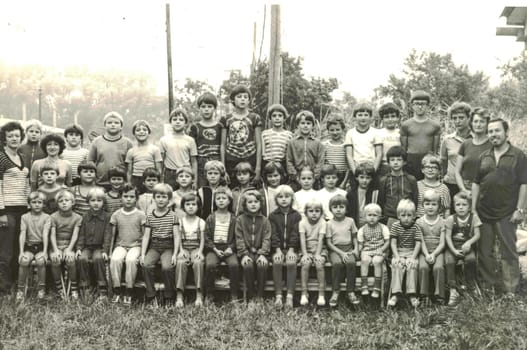 THE CZECHOSLOVAK SOCIALIST REPUBLIC - CIRCA 1980s: Retro photo of group of school pupils (young pioneers) with their teachers at summer camp. Black white photo