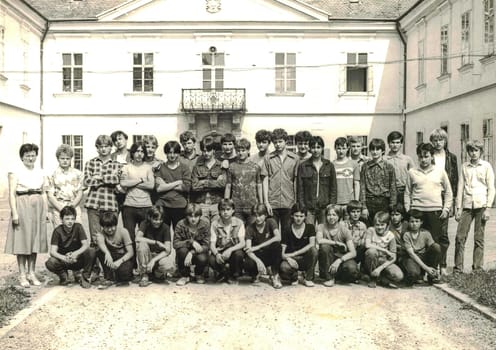 THE CZECHOSLOVAK SOCIALIST REPUBLIC - CIRCA 1980s: Retro photo shows group of school students (boys) with their female teacher. Students of technical school. Black white photo