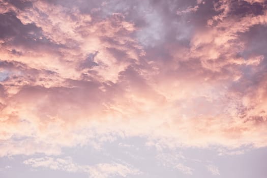 A pink and purple sky with clouds in the background.