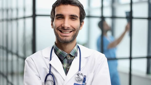 Portrait of young doctor standing in hospital hall