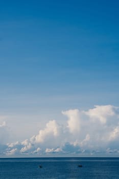 A blue sky with cumulus cumulus fluffy huge summer sun white clouds.