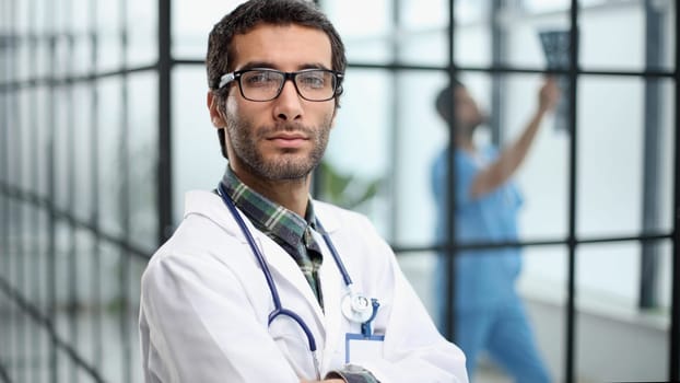 mature doctor posing and smiling at camera, healthcare and medicine.