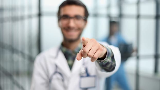 Young doctor in nurse or surgeon uniform showing and pointing fingers number one