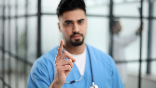 A portrait male doctor pointing at a copy space