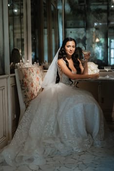 portrait of a bride in a white dress in a bright cafe with mirrors