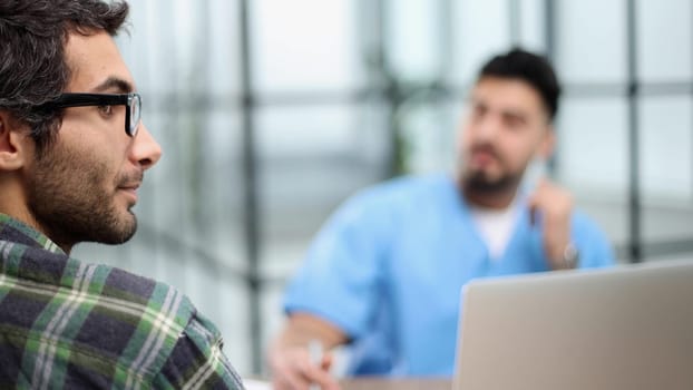 Doctor talking to a patient in a consultation at the office