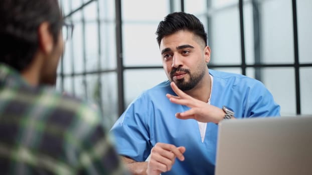 male doctor consulting patient filling form at consultation.