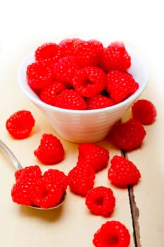 bunch of fresh raspberry on a bowl and white wood rustic  table