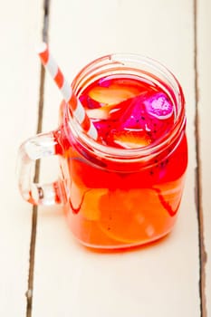 fresh fruit punch refreshing summer  drink over white rustic wood table